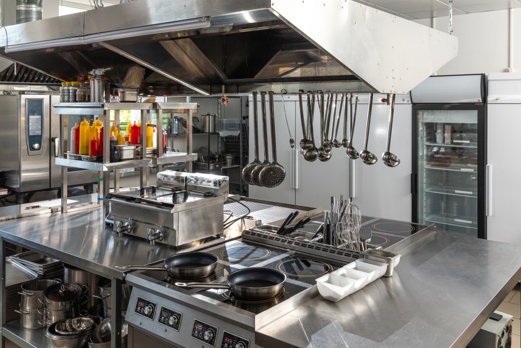 Restaurant kitchen with stainless steel range and appliances